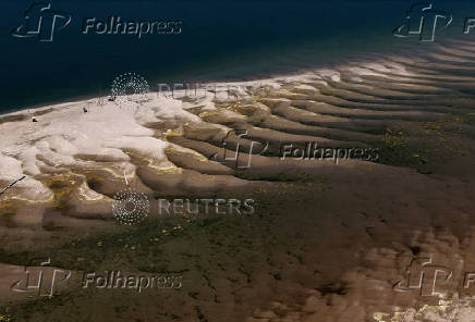 People sunbathe on sandbank on Danube near Ruse
