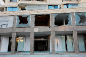 A damaged building stands in Sweida