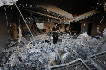 Palestinians inspect damage inside the Al-Ahli Arab Baptist Hospital in Gaza City