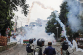 Security forces throw tear gas cans and sound grenades to disperse the Awami League supporters following a clash during the National Citizen Party rally, in Gopalganj