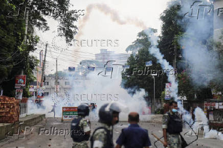 Security forces throw tear gas cans and sound grenades to disperse the Awami League supporters following a clash during the National Citizen Party rally, in Gopalganj