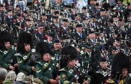 Members of a Pipe band march during the Braemar Royal Highland Gathering at the Princess Royal and Duke of Fife Memorial Park in Braemar