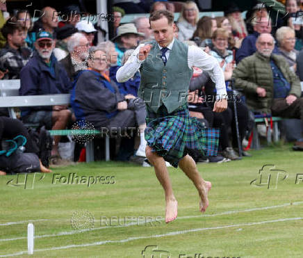 A competitor takes part in a track event during the Braemar Royal Highland Gathering at the Princess Royal and Duke of Fife Memorial Park in Braemar, Scotland