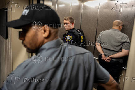 A handcuffed New York Democratic State Senator Gustavo Rivera is placed in an elevator after participating in a sit in and being denied access to inspect the conditions of detainment cells at U.S. immigration court in Manhattan