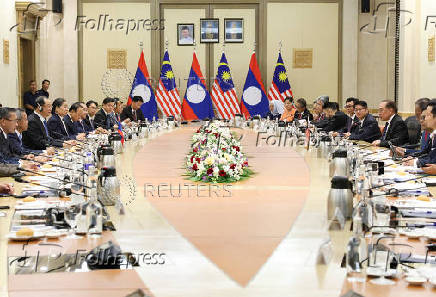 The Prime Minister of Laos meets his Malaysian counterpart during his visit to Malaysia