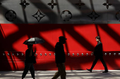 People walk in front of the new Louis Vuitton store in Shanghai