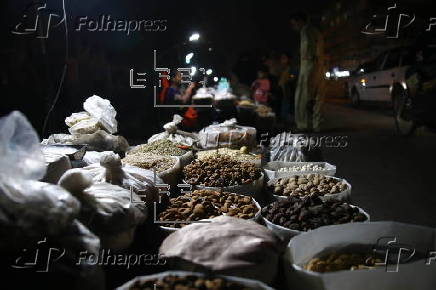 Street vendor sells dry fruits on a roadside in Karachi