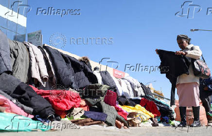 A women checks for items at amakeshift stall selling clothes in Maseru