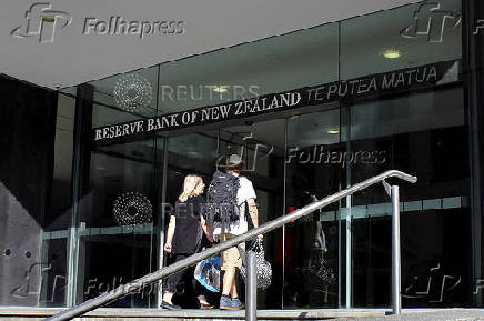 FILE PHOTO: Two people walk towards the entrance of the Reserve Bank of New Zealand located in the New Zealand capital city of Wellington
