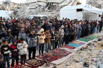 Palestinian Muslims attend Eid al-Fitr prayer in Jabalia