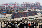 FILE PHOTO: Gantry cranes stand near shipping containers at Yangshan Port outside of Shanghai