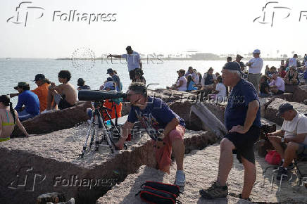 People wait to watch SpaceX's next-generation Starship spacecraft atop its Super Heavy booster launch