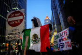 People protest against federal immigration sweeps, next to the U.S. immigration court at the Jacob K. Javits Federal Building, in New York