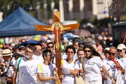 LGBTQ+ pilgrims walk toward St. Peter's Basilica