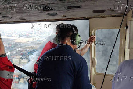 Iranian Red Crescent rescuers work following an explosion at the Shahid Rajaee port in Bandar Abbas
