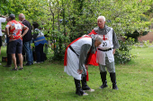 Competitors participate in the Pinner Wheelbarrow Race as part of a St. George's Day celebration, in London