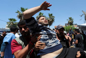 Palestinian casualties are brought into Al-Aqsa Martyrs Hospital, following an Israeli strike, in Deir al-Balah