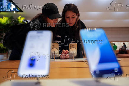 People visit Apple's Fifth Avenue store in New York City
