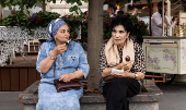 Women eat ice cream in central Moscow