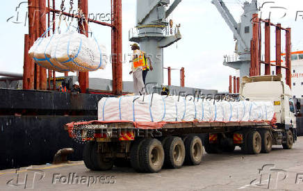 Workers unload a shipment of rice from the MV Amira Sophie II, at the Kenya Ports Authority (KPA) container terminal in the port of Mombasa