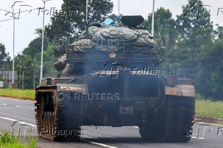 A tank drives on a road toward Thailand-Cambodia's border in Sisaket province, ahead of a ceasefire talks in Malaysia on the deadly border conflict between Thailand and Cambodia