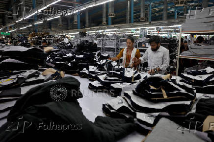Workers sort denim fabric after it was cut in a garment manufacturing unit on the outskirts of Ahmedabad