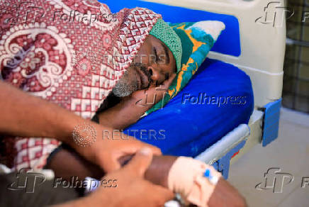 A dengue fever patient receives intravenous fluids at a hospital in Khartoum