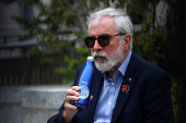 Former Sinn Fein President Gerry Adams sits outside the High Court, in Dublin