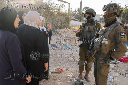 Israeli soldiers prevent Palestinians who came to visit the graves of their relatives from reaching the cemetery in Jenin camp