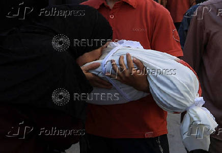 A mourner reacts near the body of a Palestinian killed in an Israeli strike, in Gaza City