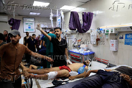 Palestinian casualties of Israeli fire, who were seeking aid, according to medics, are assisted at Nasser Hospital in Khan Younis, southern Gaza Strip
