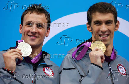 FILE PHOTO: Gold medallist Michael Phelps of the U.S. and silver medallist and compatriot Ryan Lochte hold their medals during the men's 200m individual medley victory ceremony during the London 2012 Olympic Games