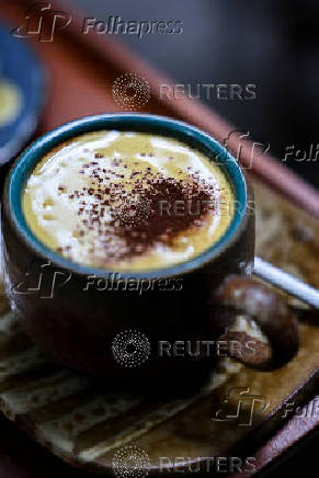 A cup of egg coffee, a Vietnamese drink traditionally prepared with egg yolks, is placed on a surface at a cafe in Hanoi