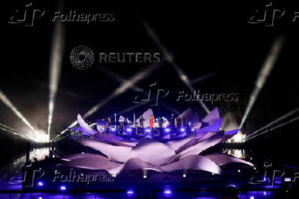 Mariah Carey performs on a floating stage shaped like a giant Victoria amazonica water lily at the Guama River in Belem