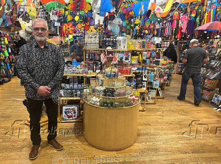 Paul Kusler, vice president of the Into the Wind kite and toy store, poses for a photo, in Boulder