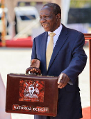 Uganda Minister for Finance Matia Kasaija holds the briefcase containing the Government Budget for the 2025/26 fiscal year at the Kololo Independence grounds in Kampala