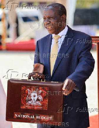 Uganda Minister for Finance Matia Kasaija holds the briefcase containing the Government Budget for the 2025/26 fiscal year at the Kololo Independence grounds in Kampala