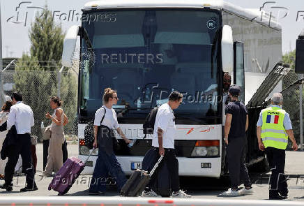 French nationals evacuated from Israel to Cyprus walk outside the Joint Rescue Coordination Center 