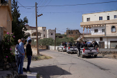 Syrian security forces deployed in the village of Al-Soura al-Kubra