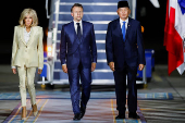 French President Emmanuel Macron and his wife, Brigitte Macron are welcomed by Indonesian Defence Minister Sjafrie Sjamsoeddin, upon their arrival at military airbase Halim Perdanakusuma in Jakarta