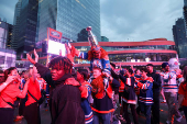 Edmonton Oilers fans react in a fan zone during the first game of the Stanley Cup Finals against the Florida Panthers, in Edmonton