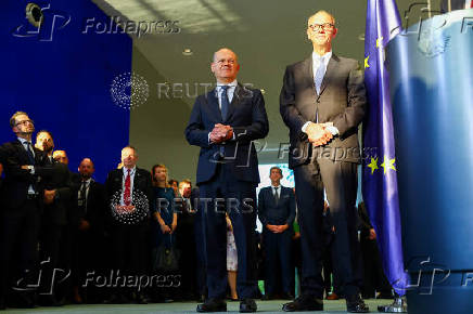 German Chancellor Olaf Scholz hands over to his successor Friedrich Merz