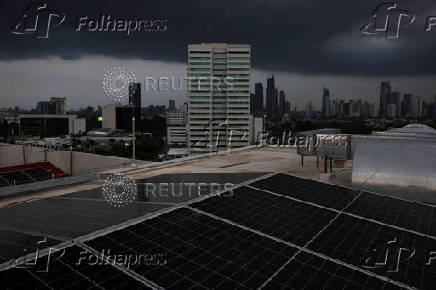 FILE PHOTO: Solar panels sit on the rooftop of an office building in Jakarta