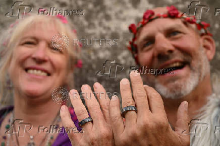 Revellers attend summer solstice celebrations during sunrise at Stonehenge near Amesbury