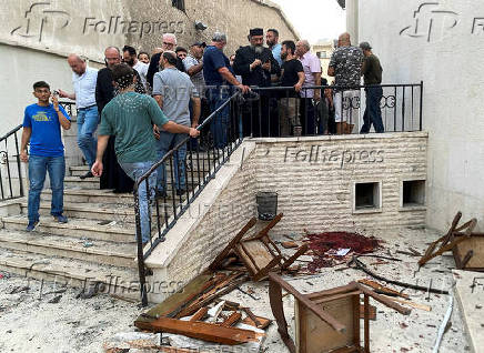 People gather at a damaged site after a blast rocked the Mar Elias Church in the Dweila neighbourhood of Damascus