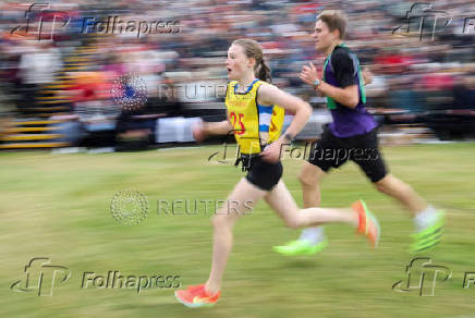 Competitors take part in a track event during the Braemar Royal Highland Gathering at the Princess Royal and Duke of Fife Memorial Park in Braemar, Scotland