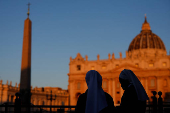 Nuns stand in front of St. Peter's Basilica, ahead of the conclave which will be held on May 7, as seen from Rome