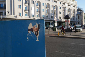 A torn electoral poster of Nicusor Dan is seen in Bucharest