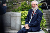 Former Sinn Fein President Gerry Adams sits outside the High Court, in Dublin