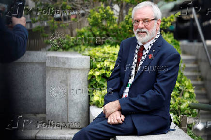 Former Sinn Fein President Gerry Adams sits outside the High Court, in Dublin